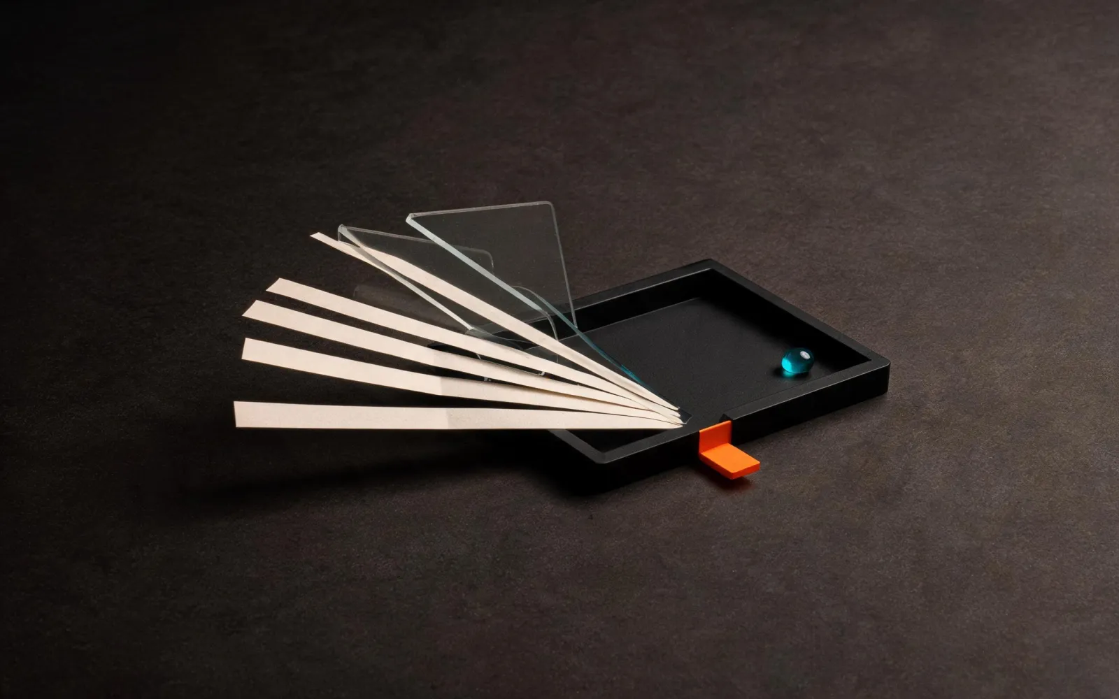 Paper and acrylic inputs converging into one black tray